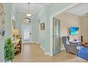 Elegant entryway showcasing light-colored walls, pendant lighting, and an open view into the adjacent living area at 3604 Corsica Ln, Clermont, FL 34711