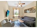 Cozy living room features a window view, TV, neutral walls, carpet, and comfortable seating at 3604 Corsica Ln, Clermont, FL 34711