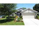 Inviting single Gathering home featuring mature landscaping and a two-car garage at 3716 Eversholt St, Clermont, FL 34711
