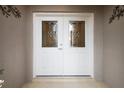 Elegant double front doors with decorative glass panels and stylish hardware at 5071 Harbour Dr, Oxford, FL 34484