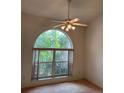 Arched window with lots of natural light and ceiling fan at 5268 Sw 110Th Pl, Ocala, FL 34476