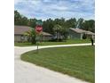 View of a quiet street and well-maintained landscaping at 5268 Sw 110Th Pl, Ocala, FL 34476