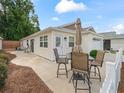 This backyard features a table and four chairs, and is perfect for relaxing and enjoying the sunshine at 5719 Spartina Ter, The Villages, FL 32163