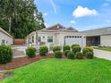 Inviting single-story home featuring a well-maintained lawn, lush greenery, and a cozy outdoor space at 5719 Spartina Ter, The Villages, FL 32163