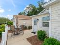 A quaint outdoor patio with a table and chairs, perfect for relaxing or enjoying al fresco meals at 5719 Spartina Ter, The Villages, FL 32163