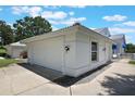 Two-car garage with white door and carriage lights, complementing the clean exterior of the home at 6036 Topsail Rd, Lady Lake, FL 32159