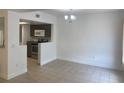 Open floor plan with tile flooring, connecting the living area to the kitchen with stainless appliances at 624 Australian Way, Davenport, FL 33897