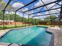 Sparkling screened-in swimming pool with brick pavers and mature landscaping offering privacy and shade at 728 Silversmith Cir, Lake Mary, FL 32746