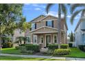 Inviting two-story home with a cozy front porch, beautiful landscaping, and a well-maintained lawn at 7901 Iceland Gull St, Winter Garden, FL 34787