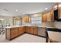 Well-lit kitchen featuring tile flooring, stainless steel appliances, and wood cabinetry at 953 Mayo Ct, The Villages, FL 32162