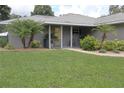 Charming single-story home with well-manicured lawn and tropical landscaping at 1007 Cr 463B, Lake Panasoffkee, FL 33538