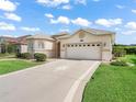 Charming home with a large two-car garage and well-maintained lawn, perfect for suburban living at 10927 Se 168Th Loop, Summerfield, FL 34491
