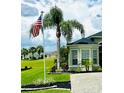 This house features a lush lawn and mature landscaping with beautiful curb appeal at 12183 Se 178Th St, Summerfield, FL 34491