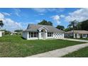 Attractive single-story home with an attached two car garage and manicured lawn on a sunny day at 12512 Draw Dr Dr, Grand Island, FL 32735