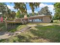 Beautiful brick home with a large deck and well-maintained landscaping at 13033 Se 158Th Ln, Weirsdale, FL 32195