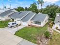 Aerial view of a neighborhood featuring single-story homes with well-kept lawns and paved driveways at 1467 Disston Ave, Clermont, FL 34711
