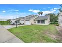 Well-maintained single-story home with lush green lawn and convenient driveway parking at 1467 Disston Ave, Clermont, FL 34711