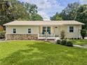 Charming single-story home with well-maintained lawn and inviting front porch seating under a bright sky at 1537 Ne 22Nd St, Ocala, FL 34470