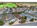 An aerial of a residential neighborhood showcasing the property with well-maintained landscaping at 1762 Meadowlark Ave, The Villages, FL 32162