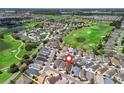 Aerial view of a golf course community featuring lush green spaces and a variety of single-Gathering homes at 1762 Meadowlark Ave, The Villages, FL 32162