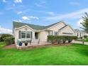 Inviting single-story home with a cozy front patio area, lush lawn, and pleasing exterior at 17860 Se 89Th Natchez Ave, The Villages, FL 32162