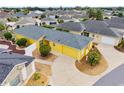 Aerial view of a charming home featuring a well-kept lawn, landscaping and driveway at 2101 Southern Star Way, The Villages, FL 32162