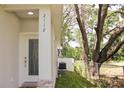 Close-up of the side of the house and decorative glass front door with stone accents at 2112 Waitman, Leesburg, FL 34748