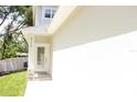 Close up of the front entry featuring a white door and stacked stone detail on the home's facade at 2114 Waitman Ave Waitman, Leesburg, FL 34748