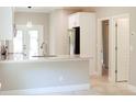 Bright kitchen with stainless steel appliances, white cabinets, and a light-colored countertop island at 2114 Waitman Ave Waitman, Leesburg, FL 34748