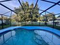 Refreshing screened-in pool area, perfect for outdoor relaxation and enjoying the serene backyard at 2122 Waseca Ln, Leesburg, FL 34748