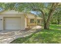 Charming single-story home with a well-manicured lawn and an attached one-car garage at 2708 Lorraine Dr, Leesburg, FL 34748