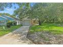 Charming single-story home with an attached garage and a well-maintained lawn and mature trees at 2708 Lorraine Dr, Leesburg, FL 34748