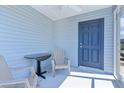 Cozy screened patio with seating offers an inviting space to enjoy the outdoors and a view of the surrounding community at 3283 Dawn Pl, The Villages, FL 32163