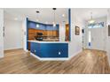 Stylish kitchen with a breakfast bar, wood cabinets and modern stainless steel appliances at 3759 Orient Ave, The Villages, FL 32163