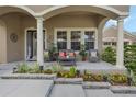 Charming front porch with decorative plants and cozy seating, perfect for relaxing outdoors at 4018 Chandler Estates Dr, Apopka, FL 32712
