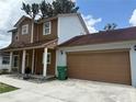 Side view of home with attached garage, showcases the home's architecture and curb appeal at 402 E Maple St, Winter Garden, FL 34787