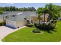 Charming home showcases a lush green lawn, mature landscaping, and a screened-in porch ideal for outdoor living at 425 Glen Arbor Ln, Leesburg, FL 34748