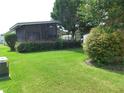 Nicely landscaped property with lush green lawn and mature shrubs at 432 Santa Fe E Rd, Tavares, FL 32778