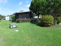 Well-maintained lawn featuring lush green grass and mature landscaping at 432 Santa Fe E Rd, Tavares, FL 32778
