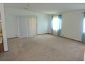 Bright living room with neutral carpet, large windows and sliding glass door at 432 Santa Fe E Rd, Tavares, FL 32778