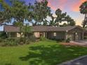 Beautiful one-story home with mature trees, green lawn, and charming curb appeal at 504 Banning Beach Rd, Tavares, FL 32778