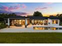 Spacious backyard with a pool, covered patio, and ample seating areas for relaxing and enjoying outdoor living at 6031 Dora Dr, Mount Dora, FL 32757