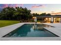 Inviting pool and spa area with an outdoor kitchen and dining area, perfect for entertaining at 6031 Dora Dr, Mount Dora, FL 32757