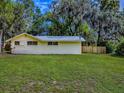 A well-manicured backyard with lush green grass and a sturdy wooden fence, enhancing privacy and charm at 6731 Lake Griffin Rd, Lady Lake, FL 32159
