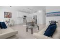 Open-concept living space with modern white furnishings and tile floors at 709 Longboat Dr, Davenport, FL 33896