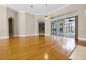 Spacious living area with hardwood floors, natural light, and sliding glass doors to the pool and patio at 7303 Spring Mountain Ln, Yalaha, FL 34797