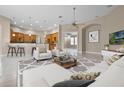 Open concept living room featuring a large seating area with views to the kitchen and breakfast bar at 7303 Spring Mountain Ln, Yalaha, FL 34797
