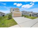 Beautiful two-story home with a large driveway and well-maintained front yard landscaping at 853 Blue Creek Dr, Haines City, FL 33844
