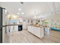 Spacious kitchen featuring an island with seating, stainless steel appliances, and lots of counter space for meal prep at 926 Saint Andrews Blvd, Lady Lake, FL 32159