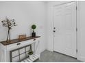 Bright entryway featuring a white door, console table, and neutral decor at 9380 La Salle St, Groveland, FL 34736